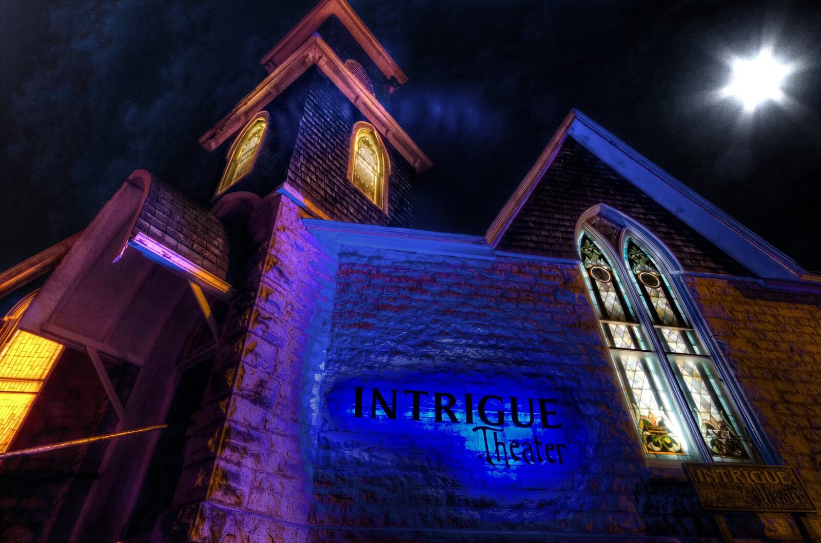 Intrigue Theater — cinematic Gothic exterior at night, Eureka Springs Arkansas